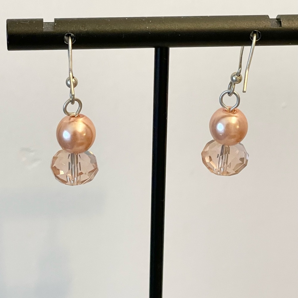 Pink bead and faux crystal earrings on silver hanger.